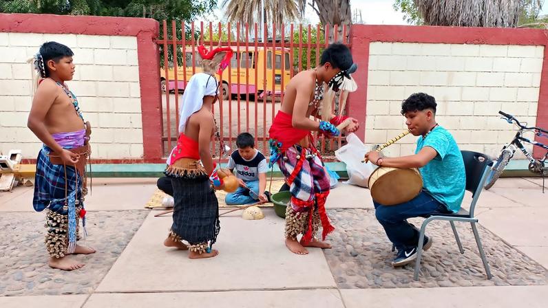 Young traditional dancers wearing ténabari around their ankles perform the danza del pascola y venado (the dance of the pascolas and the deer). Image by Mario Luna Romero.