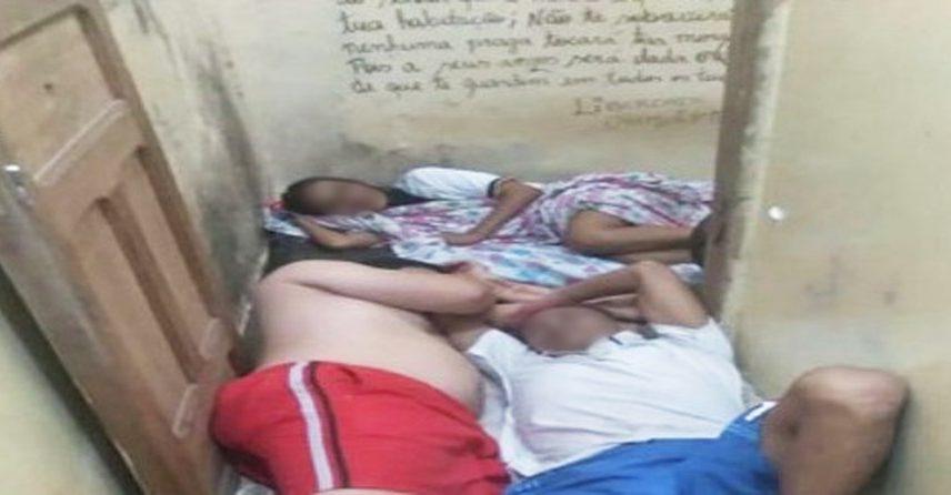 A vítima deitada com outros detentos na delegacia (Foto: Reprodução)