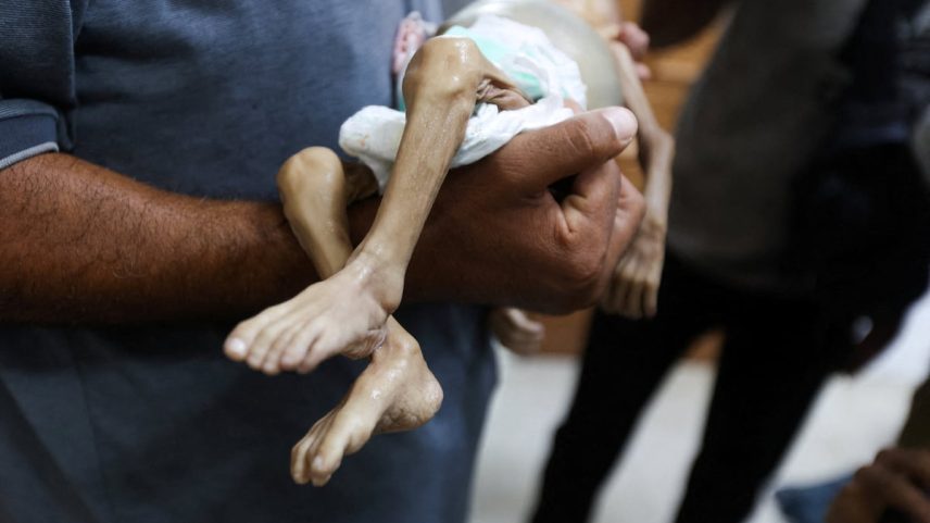 Um homem transporta o corpo da menina palestina de curta idade Zainab Abu Haleeb, que morreu por desnutrição aguda severa em Jan Yunis (Gaza), no último sábado. (Foto: Ramadan Abed/REUTERS)