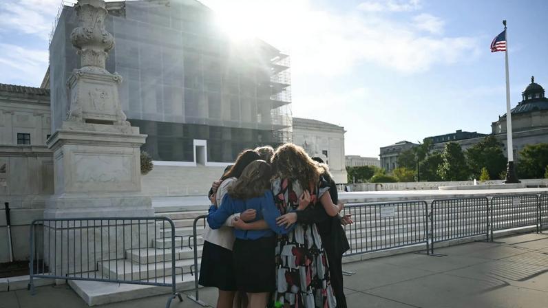 Members of the group "Concerned Women for America" pray outside the US Supreme Court as the Court hears oral arguements in Chiles v. Salazar.