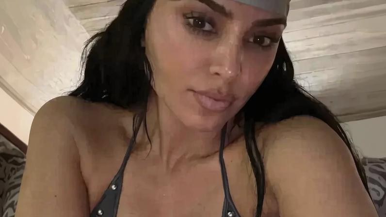 She wore this iconic dress from Alexander McQueen’s spring 2003 collection for a nighttime swim. Penske Media via Getty Images