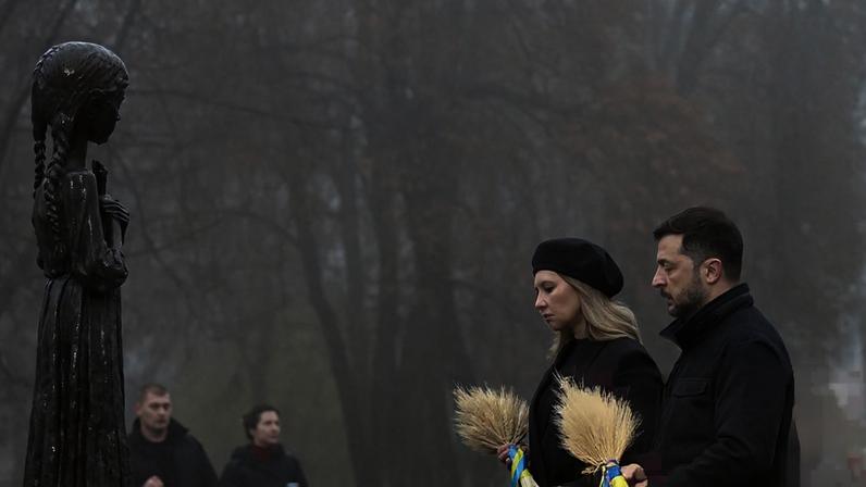 President Zelenskyy and his wife, Olena, at a monument to victims of the Holodomor famine in the 1930s, in Kyiv on Saturday. He has warned his people the Trump peace plan presents Ukraine with an impossible choice.