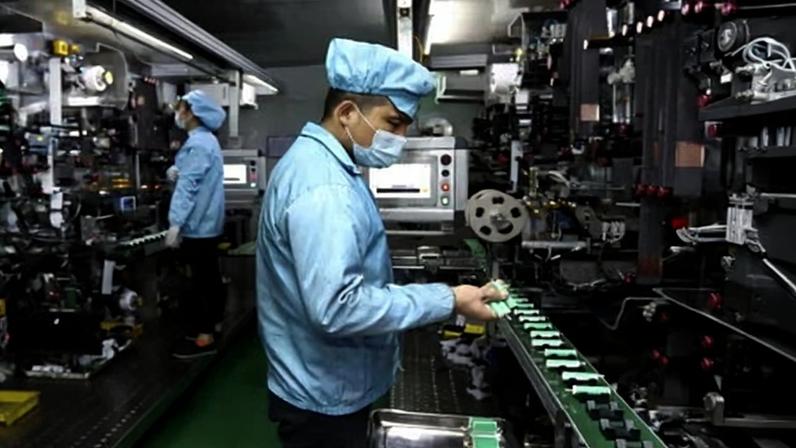 A worker places batteries on a conveyor belt at a factory in China, which has a stranglehold on supplies of many vital materials. Photograph: AP