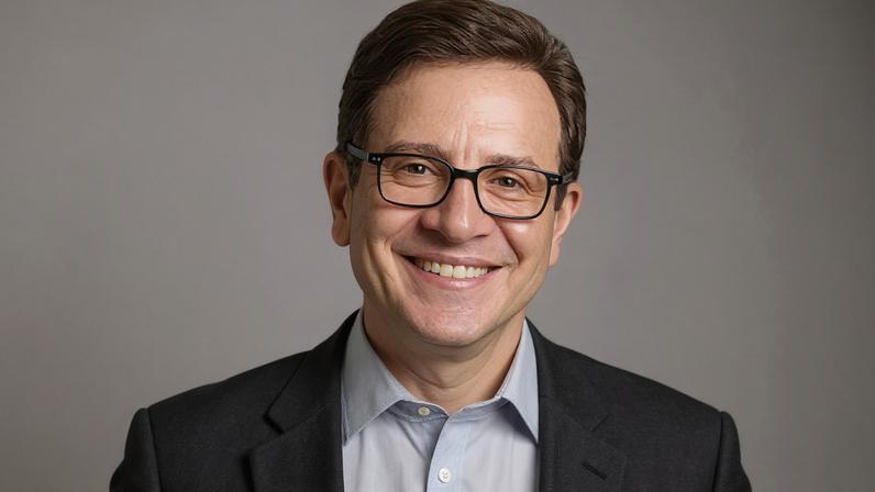 A pencil drawing of a man smiling and wearing glasses