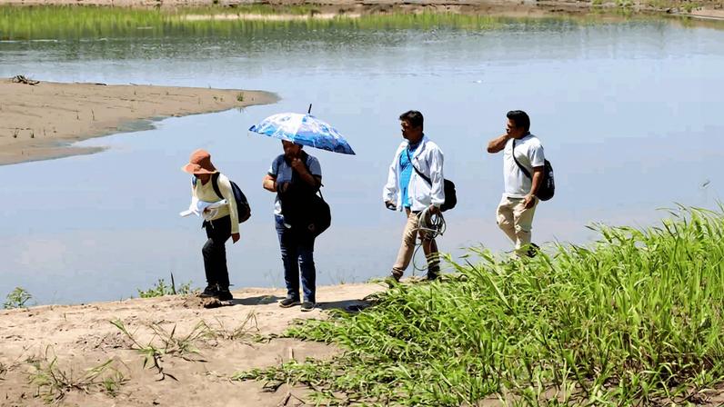 Hair sampling team near a sampling location on the Madre de Dios River.