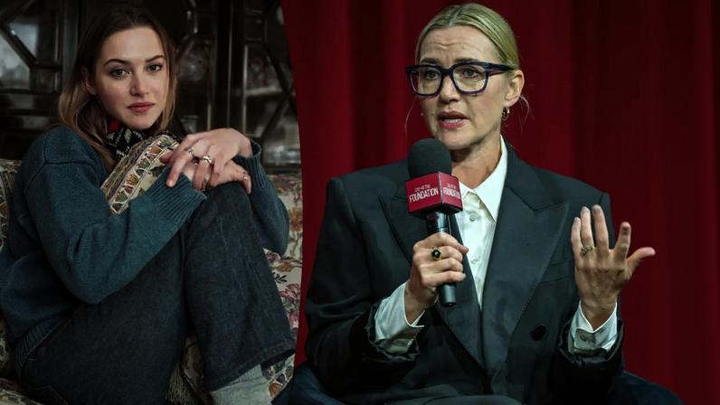 Kate Winslet, wearing dark glasses and a suit, speaks into a microphone.