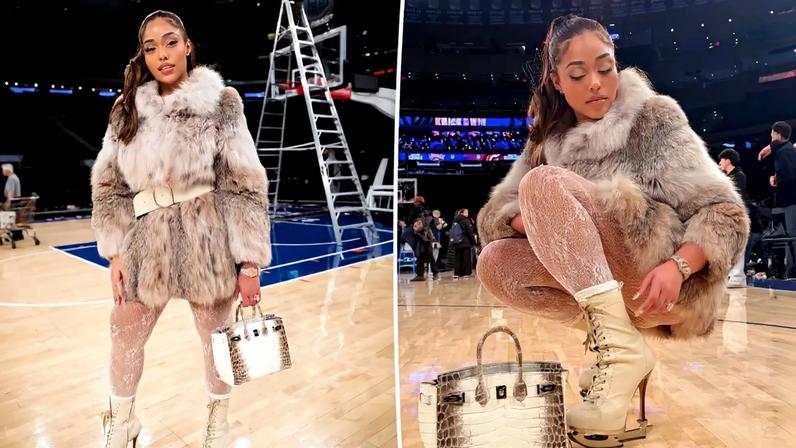 Jordyn Woods in a fur coat, white lace tights, ice-skate boots, and a Birkin bag on a basketball court.