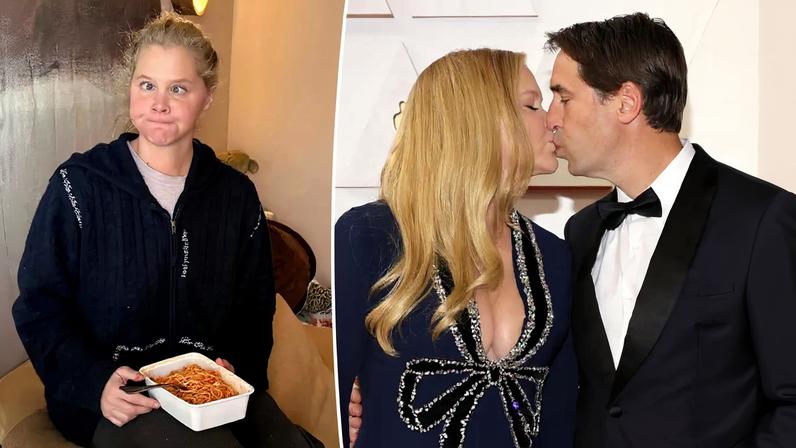 Amy Schumer makes a funny face while holding a container of spaghetti.