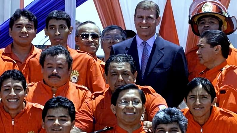 Andrew (wearing suit) poses with firefighters in Lima on 8 March 2002. ‘A’ messaged Maxwell about arrangements for a trip to Peru.