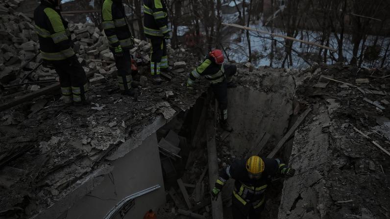 Rescuers work at the site of the apartment building hit by a Russian drone during a Russian missile and drone strike, amid Russia's attack on Ukraine, in Kyiv, Ukraine December 27, 2025. REUTERS/Viacheslav Ratynskyi