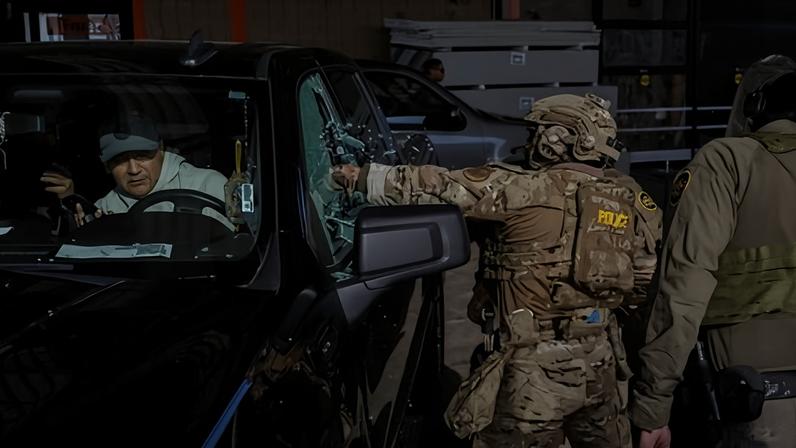 Federal agents smash a car window while trying to detain a man during an immigration raid in Chicago, Illinois, on 17 December 2025.