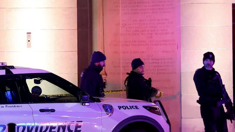 Police gather on Waterman Street in Providence, Rhode Island, outside Brown University, the site of a shooting on Saturday, while the shooter remains at large.