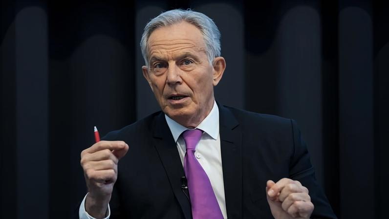 Tony Blair wears a suit with a purple tie