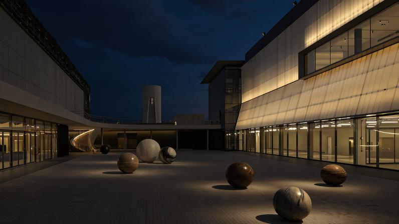 The entry court of Dib Bangkok hosts an outdoor installation of stone spheres by artist Alicja Kwade