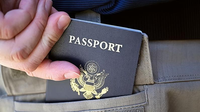 A person carries their passport in Fresno, California, on 31 July 2025.