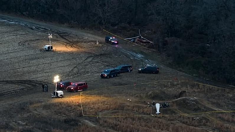 Authorities and investigators work the scene where police are securing wreckage following an inflight collision involving two helicopters in Hammonton, New Jersey, on 28 December 2025.