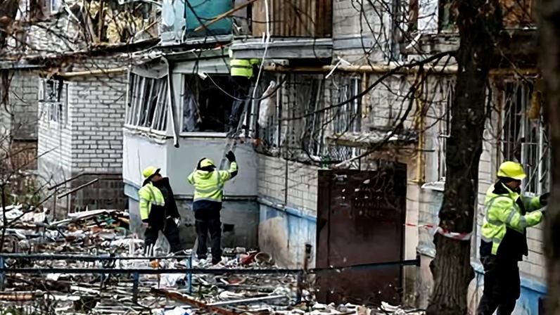 Emergency responders work at the site of a Russian drone strike on an apartment building, in Kyiv.