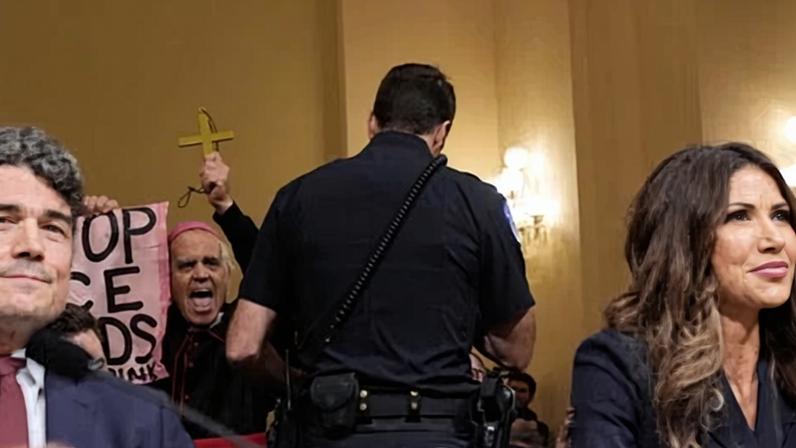 An officer stops a protester during a House hearing with homeland security secretary Kristi Noem and National Counterterrorism Center director Joseph Kent in Washington DC on Thursday. Photograph: Mark Schiefelbein/AP