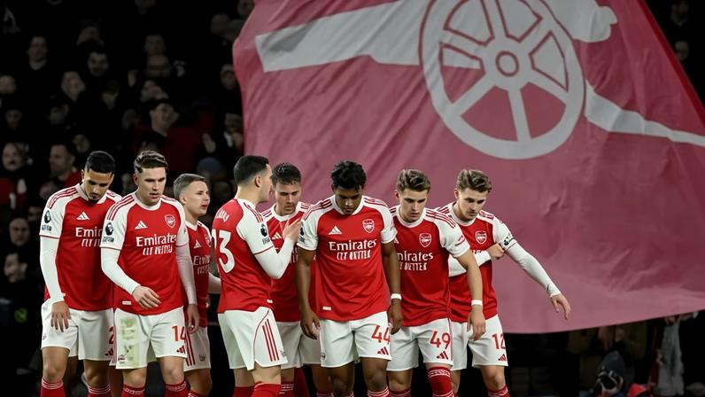 Arsenal players celebrate their first goal, an own goal scored by Wolverhampton Wanderers' Sam Johnstone.