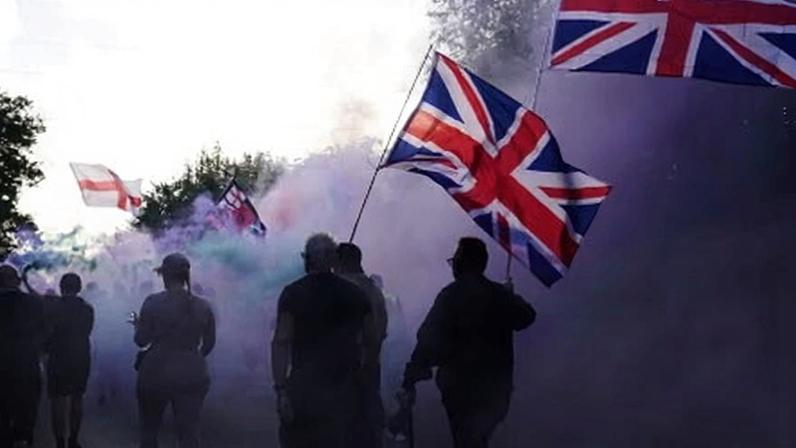 Protesters wave the union flag outside an asylum hotel in Epping near London in August.