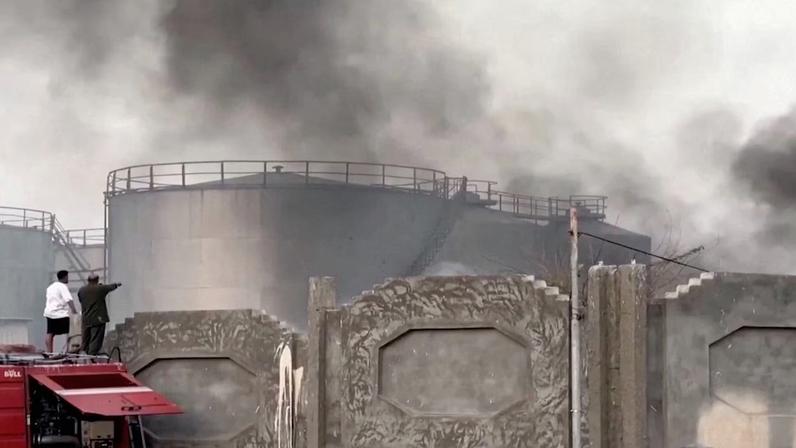 A person gestures towards smoke rising in the aftermath of a Saudi-led coalition airstrike, which targeted what it described as foreign military support to UAE-backed southern separatists, in Yemen's southern port of Mukalla, in this screengrab from a handout video obtained by Reuters on December 30, 2025. Aden al-Mustakillah TV/Handout via REUTERS