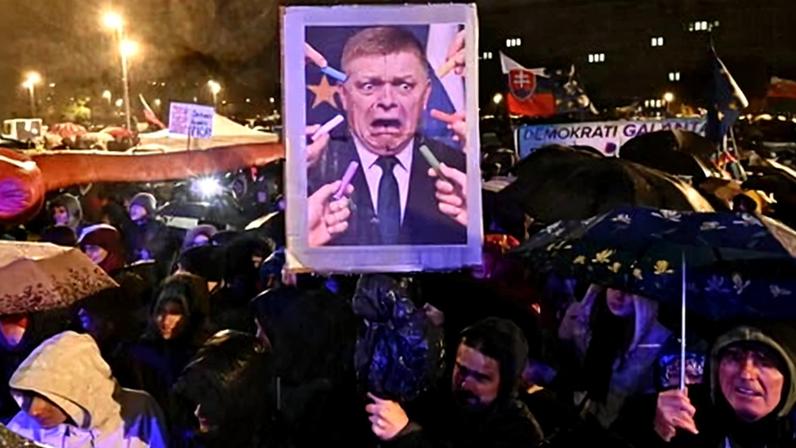 A demonstrator holds a picture depicting the prime minister, Robert Fico, being scared of chalk during a protest in Bratislava in November. Photograph: Joe Klamar/AFP/Getty Images