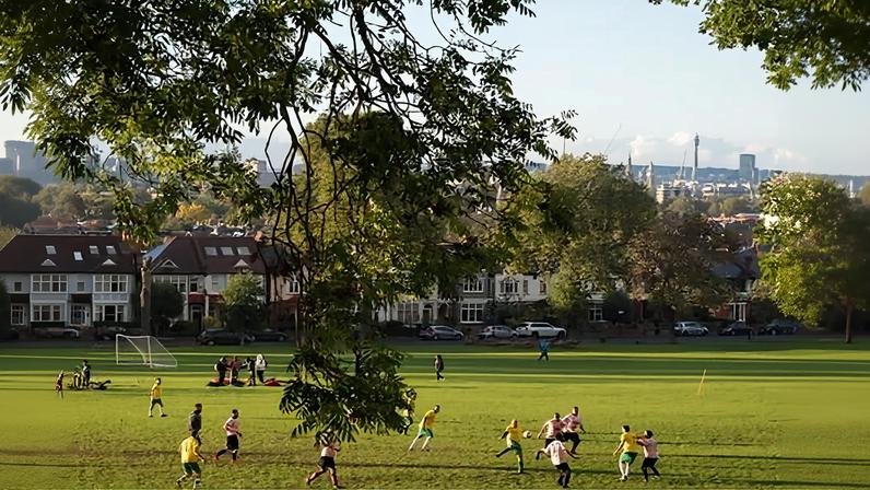 Footballers play on Ruskin Park, a public green space in south London.