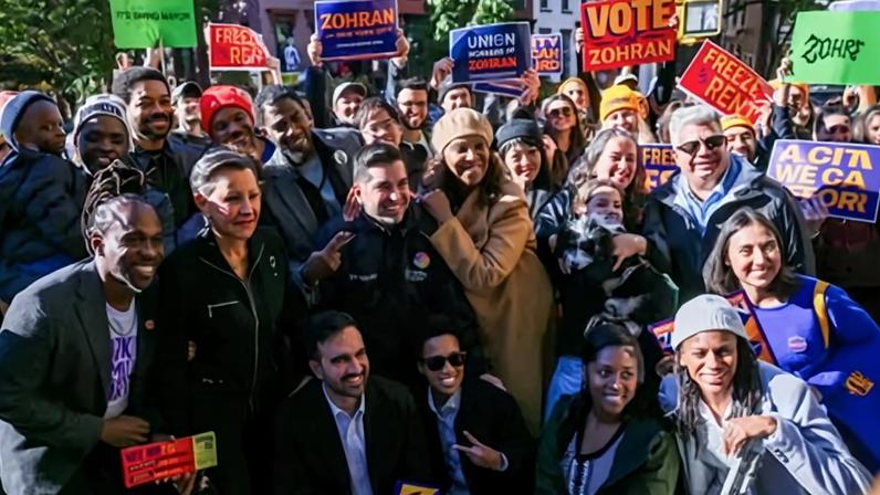 Maurice Mitchell, national director of the Working Families party, with Zohran Mamdani and voters in Brooklyn, New York, on 4 November 2025.