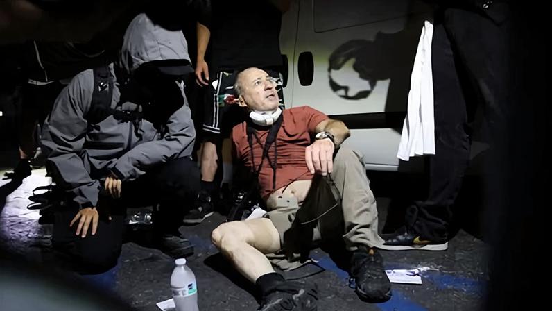 Protesters help a photojournalist during a protest in Compton, California, on 7 June 2025.