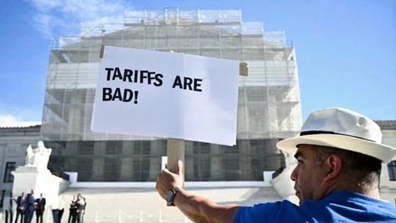 A demonstrator protests against tariffs outside the supreme court in Washington DC on 5 November 2025.