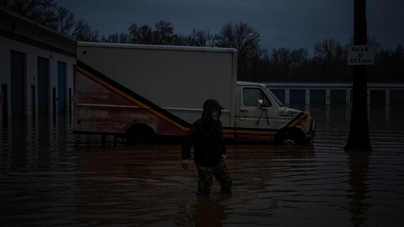 A person walks through flood water in Redding, California, on Monday.