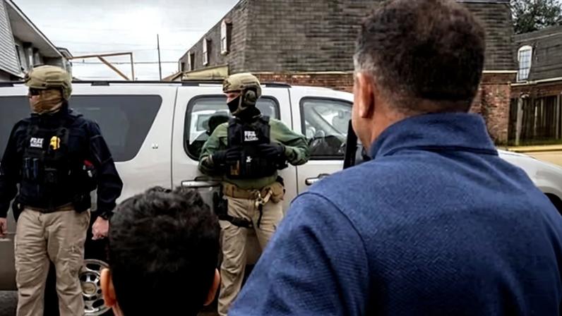 Residents ask questions as US Customs and Border Patrol commander Gregory Bovino and fellow agents conduct operations in Kenner, Louisiana, on 6 December. Photograph: Adam Gray/AFP/Getty Images