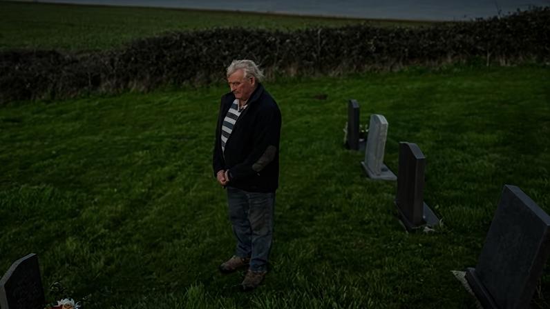 Frank Mason at St Mary the Virgin churchyard in Happisburgh, beside the grave of his parents, which is under threat from coastal erosion.