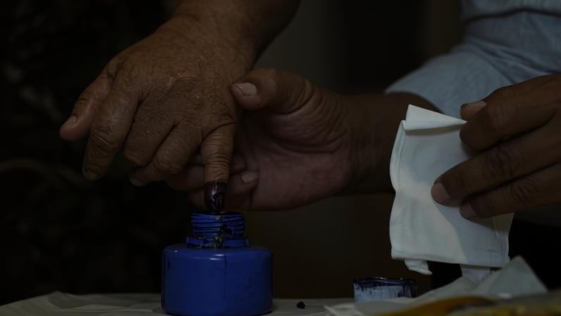 A woman has her finger inked after voting at a polling station during the first phase of Myanmar's general election in Yangon.