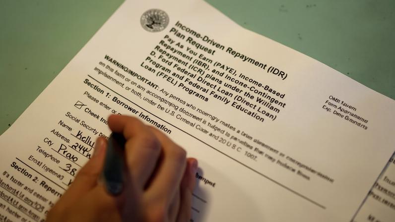 Teacher Kelly Elizabeth Belt fills out paperwork to pay back her student loan in Provo, Utah, on 30 May. Photograph: Jim Urquhart/Reuters