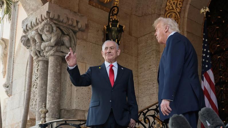 Israeli Prime Minister Benjamin Netanyahu gestures as he is welcomed by U.S. President Donald Trump for meetings at the Mar-a-Lago club in Palm Beach, Florida, U.S., December 29, 2025. REUTERS/Jonathan Ernst