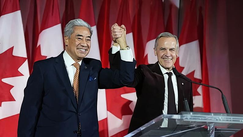 Prime minister Mark Carney raises the hand of Michael Ma, lawmaker who had crossed the floor from the Conservatives to the Liberals, at the Liberal caucus holiday party in Ottawa, on Thursday. Photograph: Canadian Press/Shutterstock