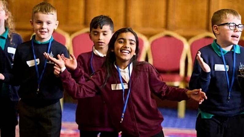 Pupils from Hill Top and Horton Grange primary schools join a Linking Network community day at Bradford City Hall.
