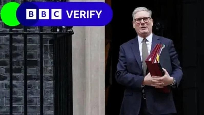 BBC Keir Starmer walking out of the door of 10 Downing Street carrying three folders. The BBC Verify lozenge is in the top left corner.