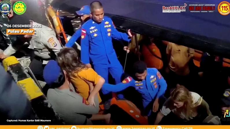Rescue teams help to depart the rescued, as Indonesia's National Search and Rescue Agency (BASARNAS) said, after a boat carrying several people sank off the coast of Indonesia in extreme weather, Spanish authorities and an Indonesian news agency said, in Indonesia, in this screengrab from the video obtained by Reuters on December 27, 2025. A Spanish family, father and three of his children, have been missing since Friday night when the boat capsized in waves of up to three meters in the Padar Island Strait. Indonesia's National Search and Rescue Agency (BASARNAS)/Handout via REUTERS