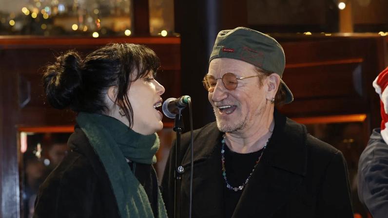 Bono and Imelda May take part in the annual Christmas Eve busk on Grafton Street in Dublin, in aid of homeless charity, the Simon Community. Picture date: Wednesday December 24, 2025. (Photo by Conor O Mearain/PA Images via Getty Images)