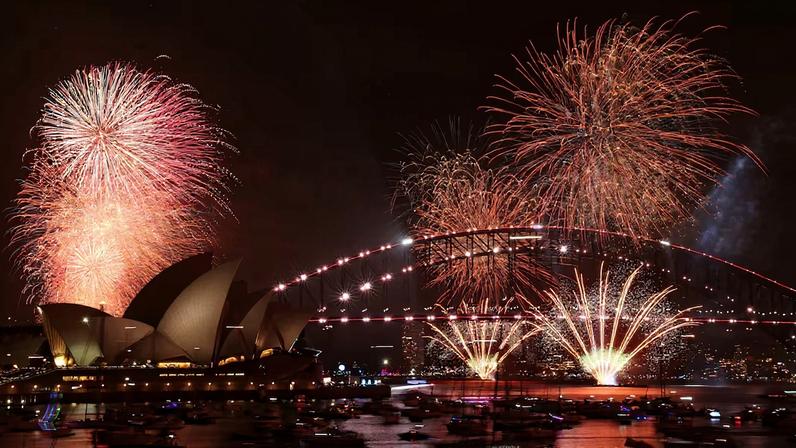 Fireworks explode over Sydney Harbour Bridge at 9 p.m. during New Year's Eve celebrations, in Sydney