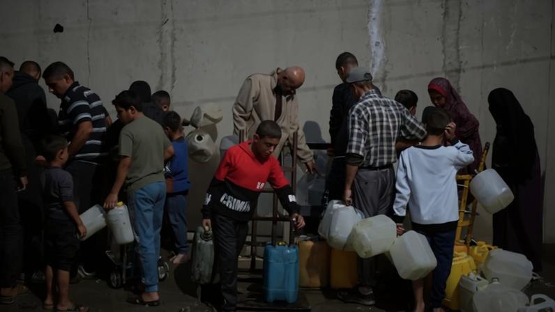 Palestinians fill containers with water at a collection point in the Nuseirat refugee camp in the central Gaza Strip on Nov. 23.
