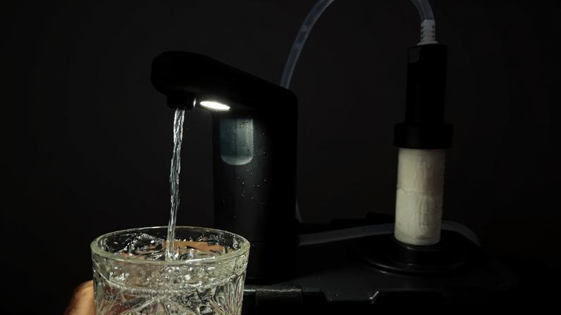 The Dometic Recon 360 Faucet pumping water out a Dometic Go Jug through a LifeStraw water filter.