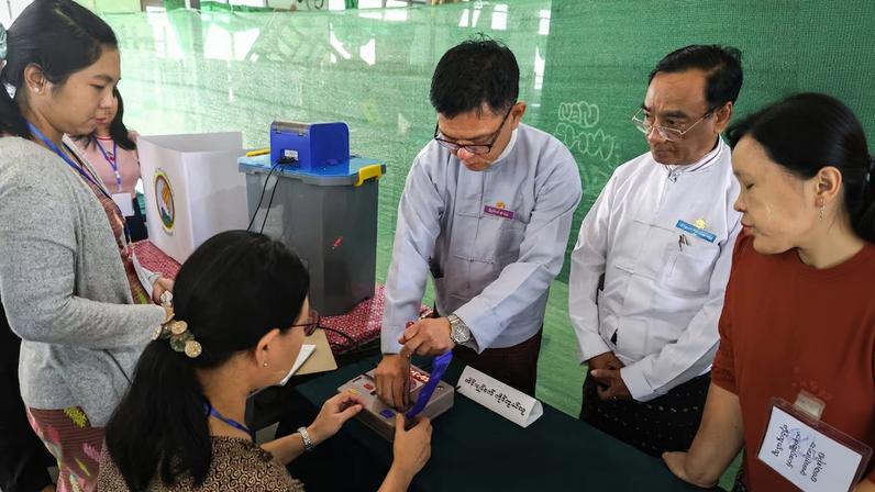 Election Commission officials prepare at a polling station inside a school ahead of a general election, in Thingangyun Township, Yangon, Myanmar, December 27, 2025. REUTERS/Stringer