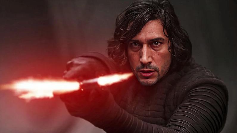 Kylo Ren holds up a red light saber.