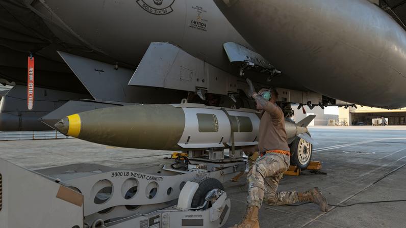 A U.S. Airman attaches a GBU-31 munitions system to an F-15E Strike Eagle in the U.S. Central Command area of responsibility, December 19, 2025, in support of Operation Hawkeye Strike as the U.S. military launched large-scale strikes against dozens of Islamic State targets in Syria in retaliation for an attack on U.S. personnel, U.S. officials said. U.S. Air Force Photo/Handout via REUTERS