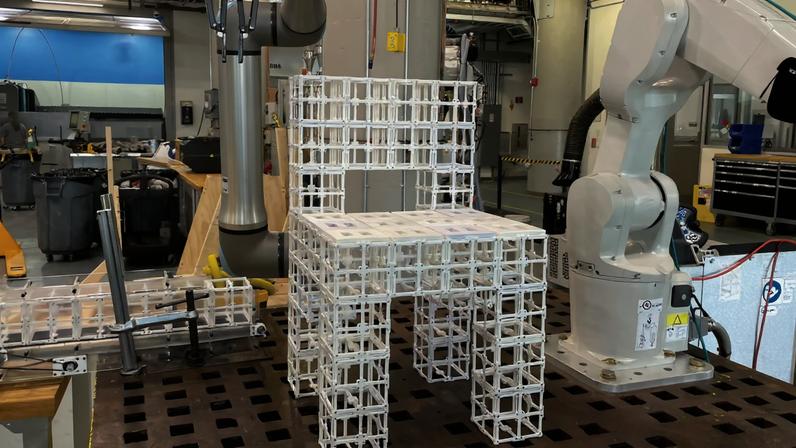 Given the prompt “Make me a chair” and feedback “I want panels on the seat,” the robot assembles a chair and places panel components according to the user prompt.