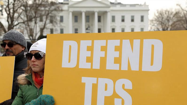 Demonstrators hold signs advocating for Temporary Protected Status (TPS) in front of the White House in Washington, D.C., U.S., January 8, 2018. REUTERS/Kevin Lamarque/File Photo