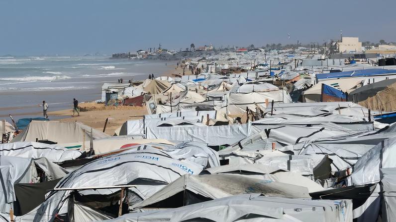 Flooded beach tent camp sheltering displaced Palestinians in Khan Younis